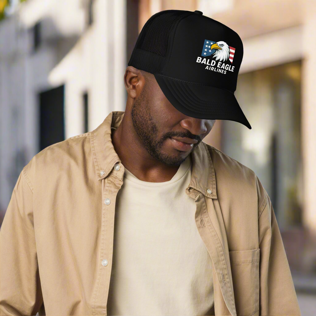 Man wearing a black cap with 'Bald Eagle Airlines' logo outdoors
