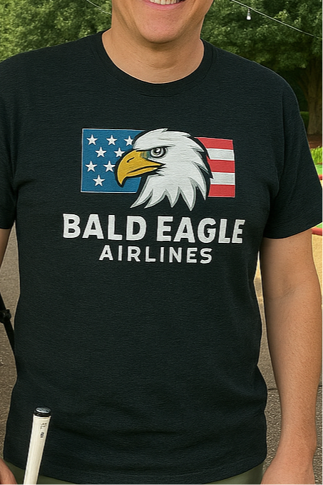 Person wearing a black t-shirt with 'Bald Eagle Airlines' design featuring an eagle and American flag.