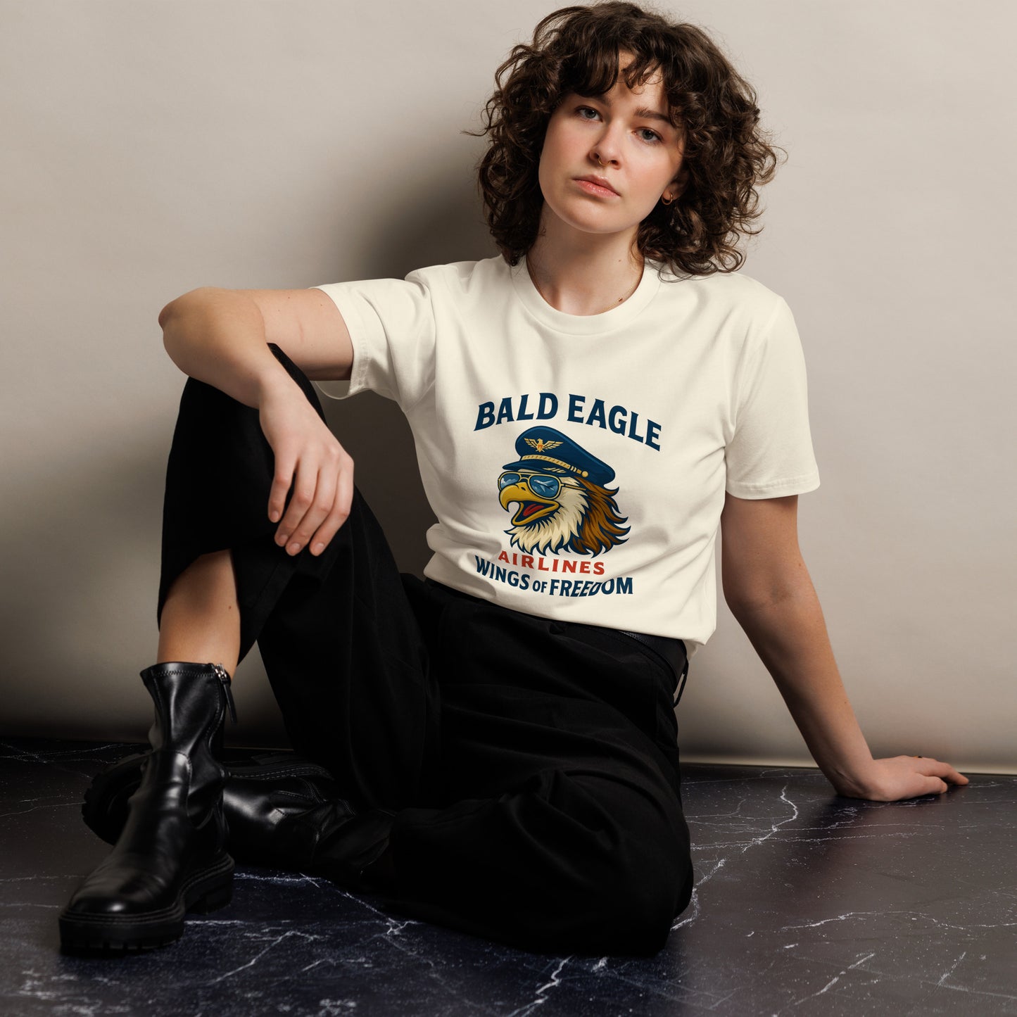 lady sitting on floor waring boots and bald eagle airlines tshirt