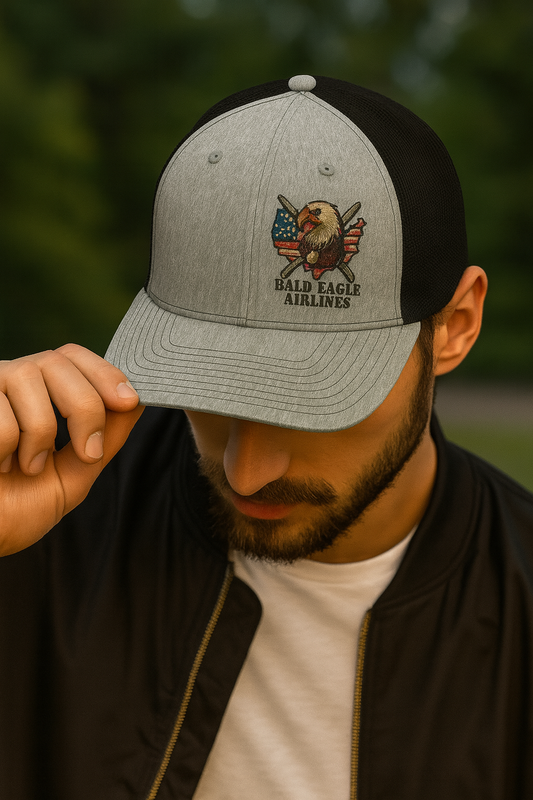 Person wearing a cap with 'Bald Eagle Airlines' logo against a blurred green background